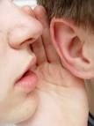 Woman Whispering In Man's Ear